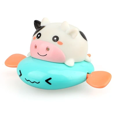 Green cute cow playing in water